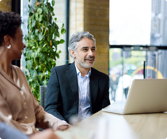 Business colleagues meeting with laptop in office