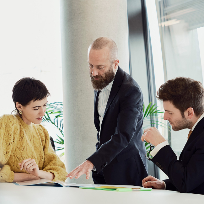 Business professionals discussing documents in modern office